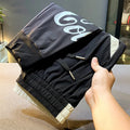 Men's black ankle band trousers with cropped casual fit in lightweight ice silk cotton fabric