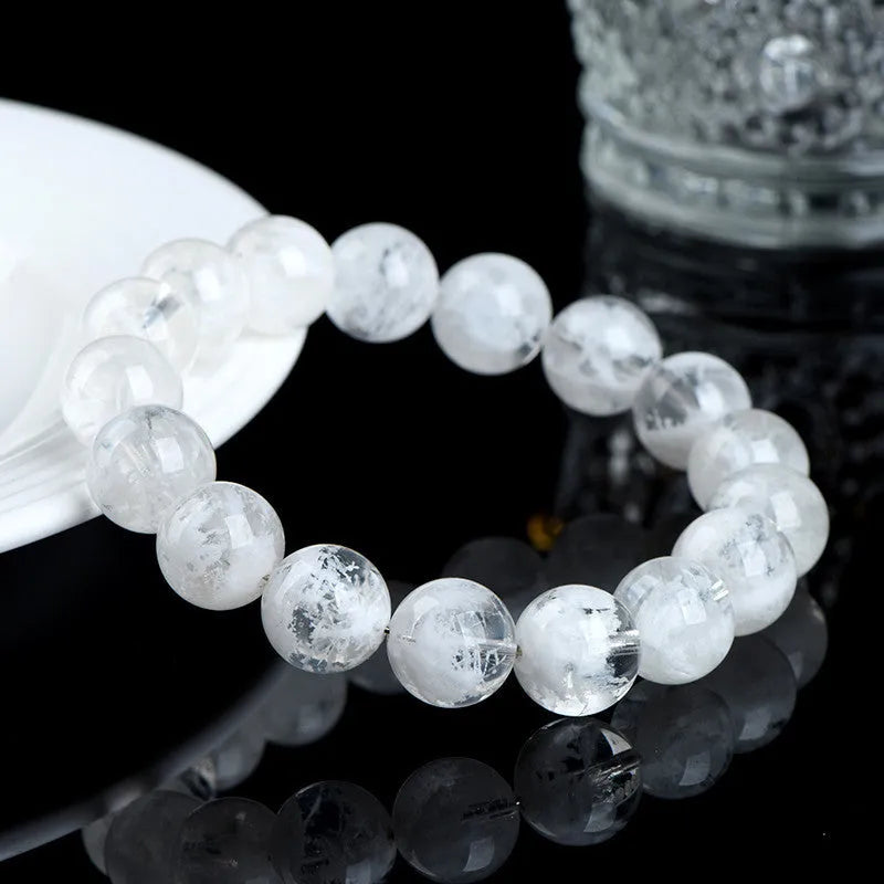 Close-up of a clear crystal blizzard snowflake bead bracelet with Ruyi and Xiangyun design elements.