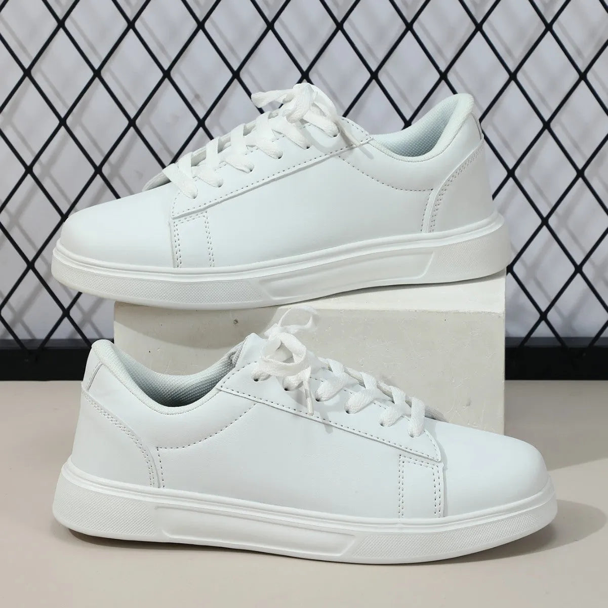 Platform skateboard casual sneaker in beige brown with low top, round toe, and a cross strap detail.