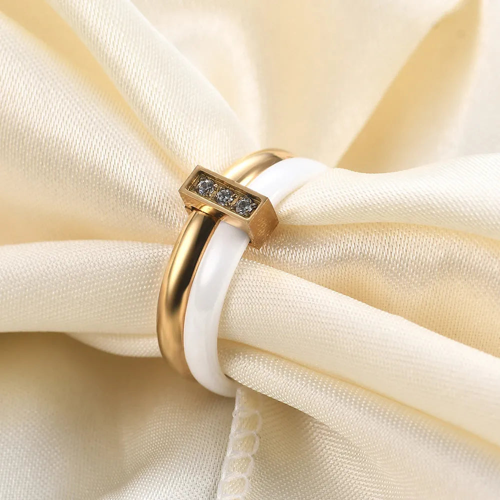 Glossy stitch and zirconium inlay ceramic ring for women in gold white on a geometric band.