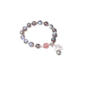 Close-up of a women's 925 sterling silver bracelet with a grey moonstone bead and a zodiac animal charm.