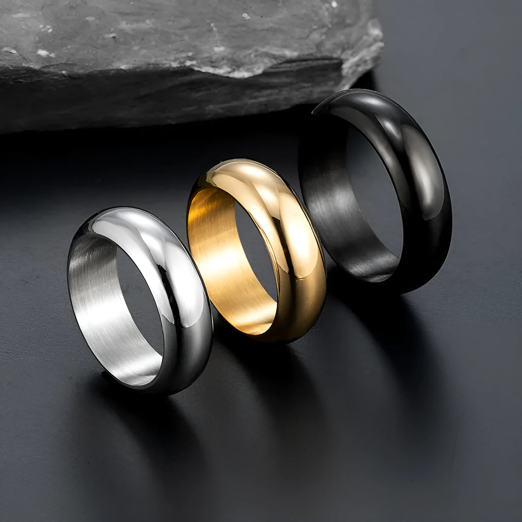 Glossy electroplated titanium steel ring in gold, black and steel colours showing metallic finish