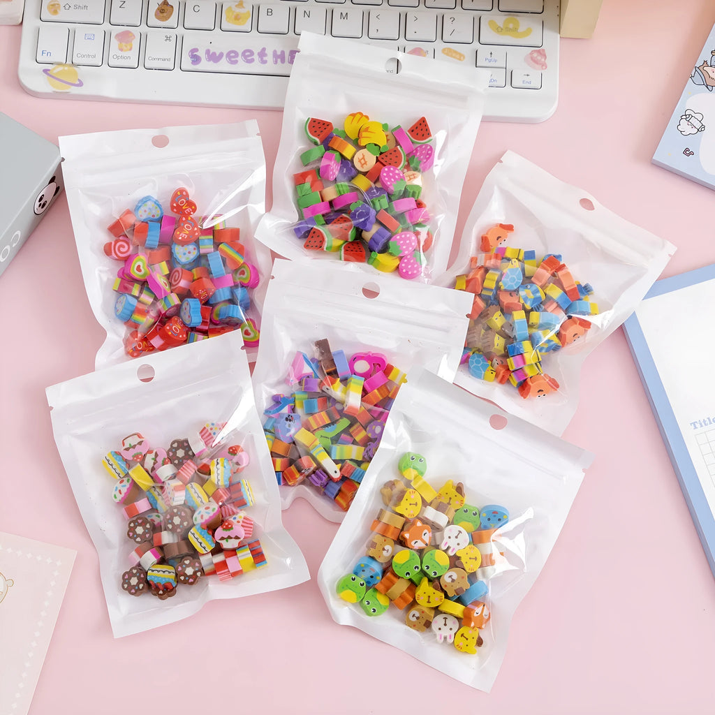 Sealed plastic bag containing 50 small cartoon-themed erasers in shapes like fruits, animals, and Christmas symbols.
