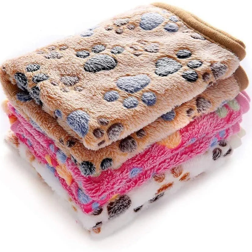 Coral fleece pet blanket with dog paw print pattern shown in beige colour, lying flat to show size
