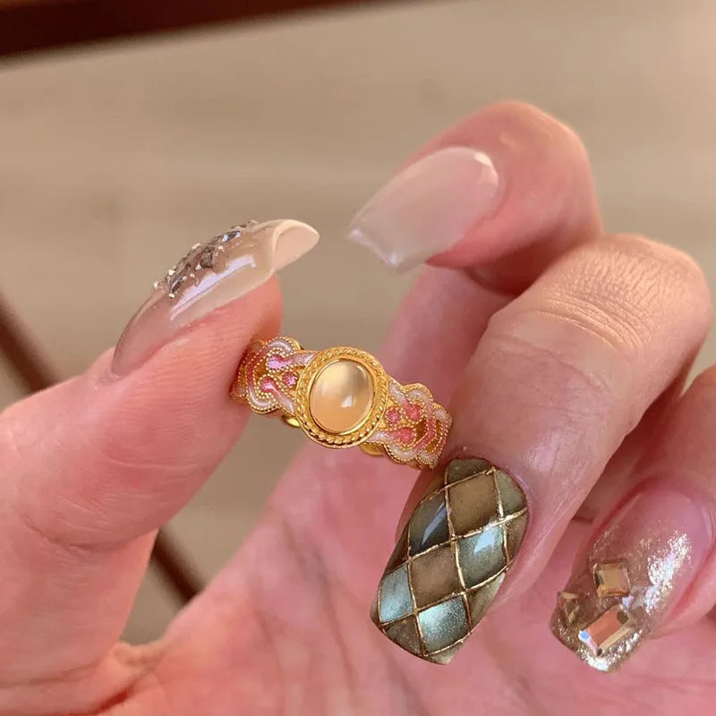 Geometric open ring for women in gold-plated copper with a pink crystal enamel detail.