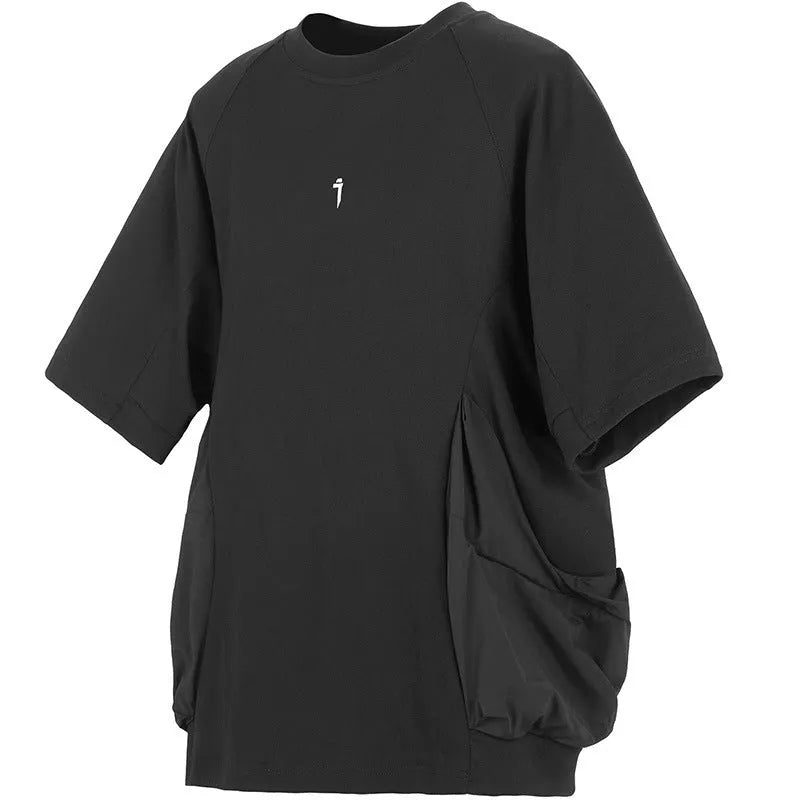 A man's loose black cotton T-shirt with large chest pockets and short sleeves.