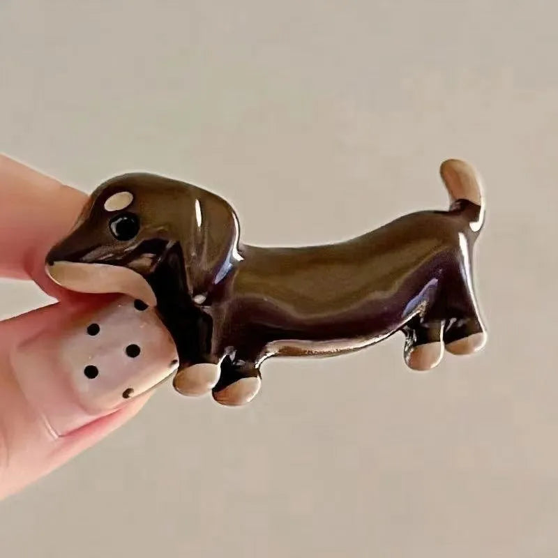 Dachshund dog shaped hair barrettes with electroplated finish, shown as a single clip or a pair.