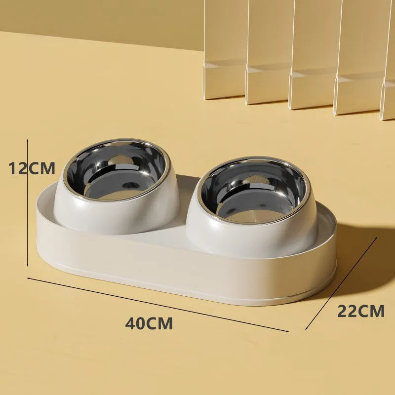 White elevated pet feeder with two tilted bowls on a wide base, for cats and small dogs.