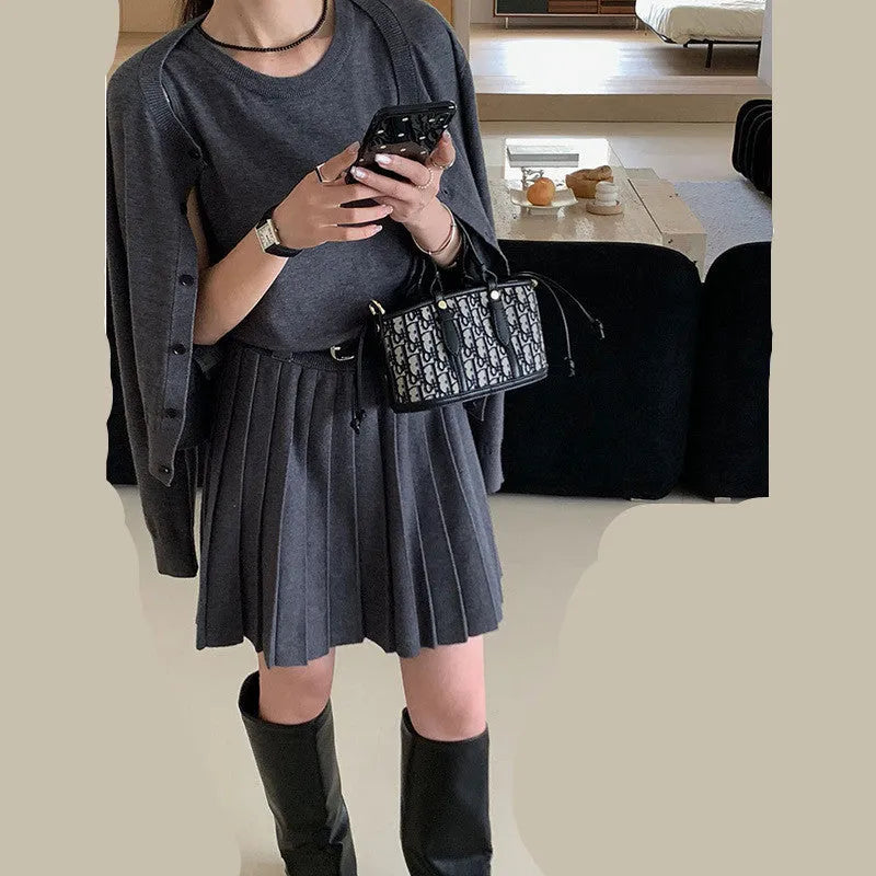 Grey art retro knitted two-piece set with 3D pattern, featuring a pleated vest skirt with belt and a V-neck long-sleeve cardigan.