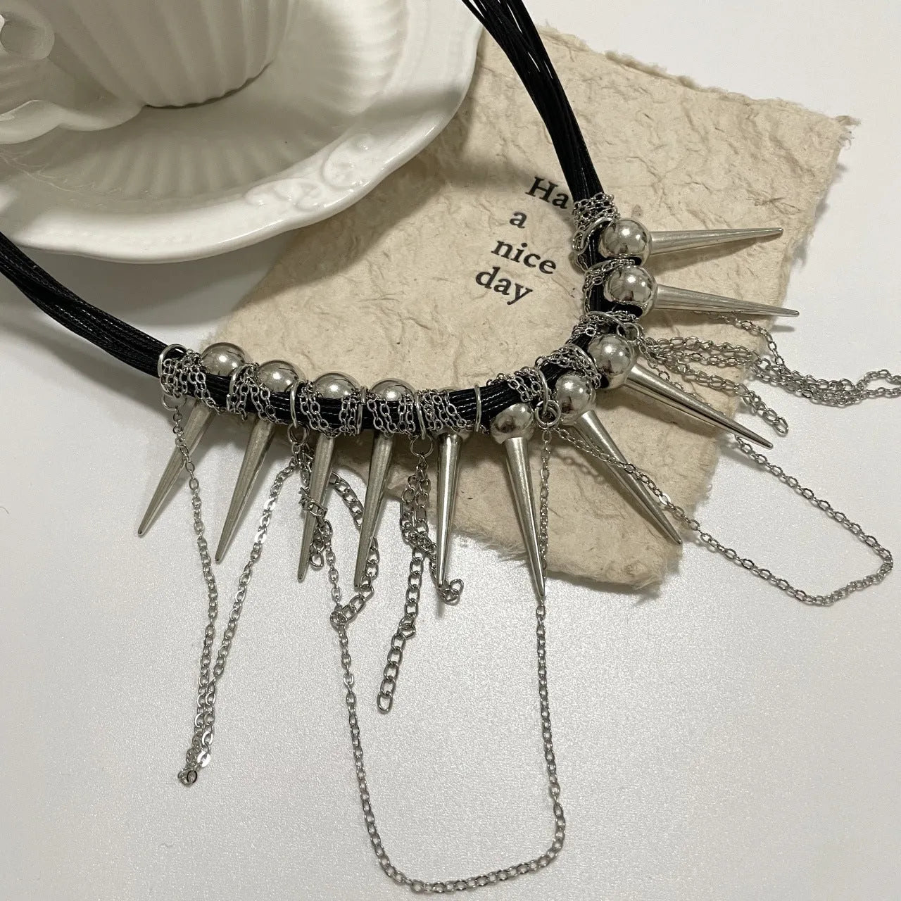 Women's casual leather necklace with electroplated rivets and winding round beads in picture colour.