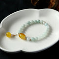 Women's ethnic geometric bracelet with hanging red agate beads and 14K gilded finish