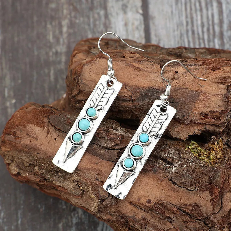 Women's silver geometric long strip earrings with turquoise detail and retro styling