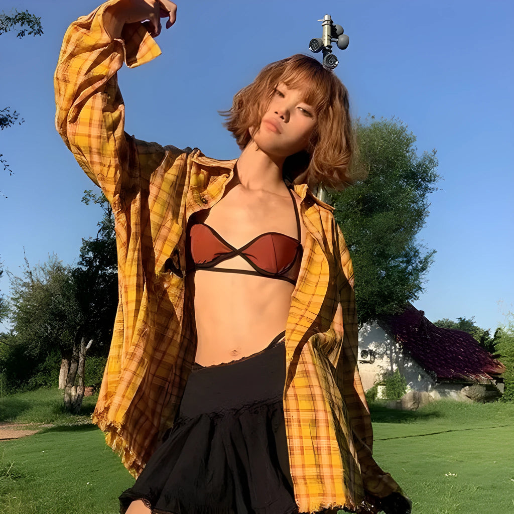 Dopamine yellow and black plaid shirt with a loose cardigan style fit on a hanger.