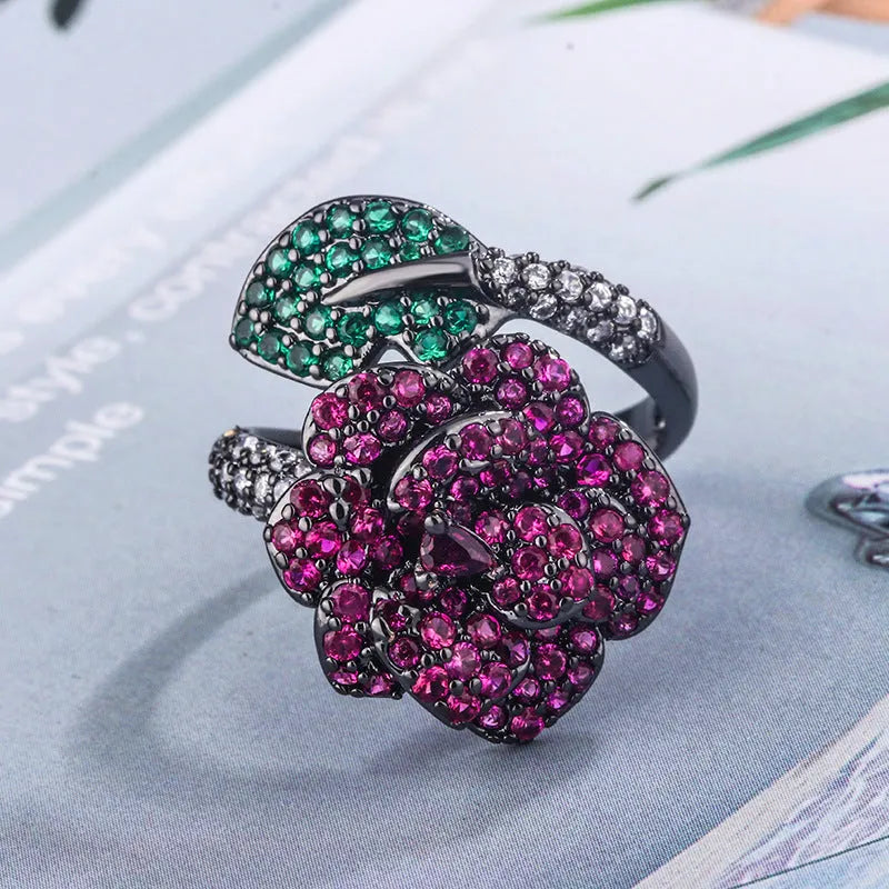 Geometric black gold plated flower ring with red simulated corundum stones for women.