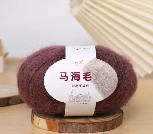 Ball of mohair yarn for DIY scarf knitting in one of 34 colours, including white, pink, blue, and green.