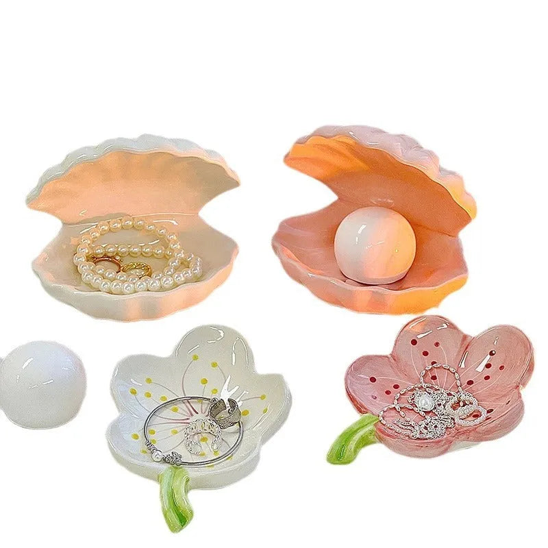 White porcelain storage tray with optional small night light, shown in pink and white shell colours on a wooden surface.
