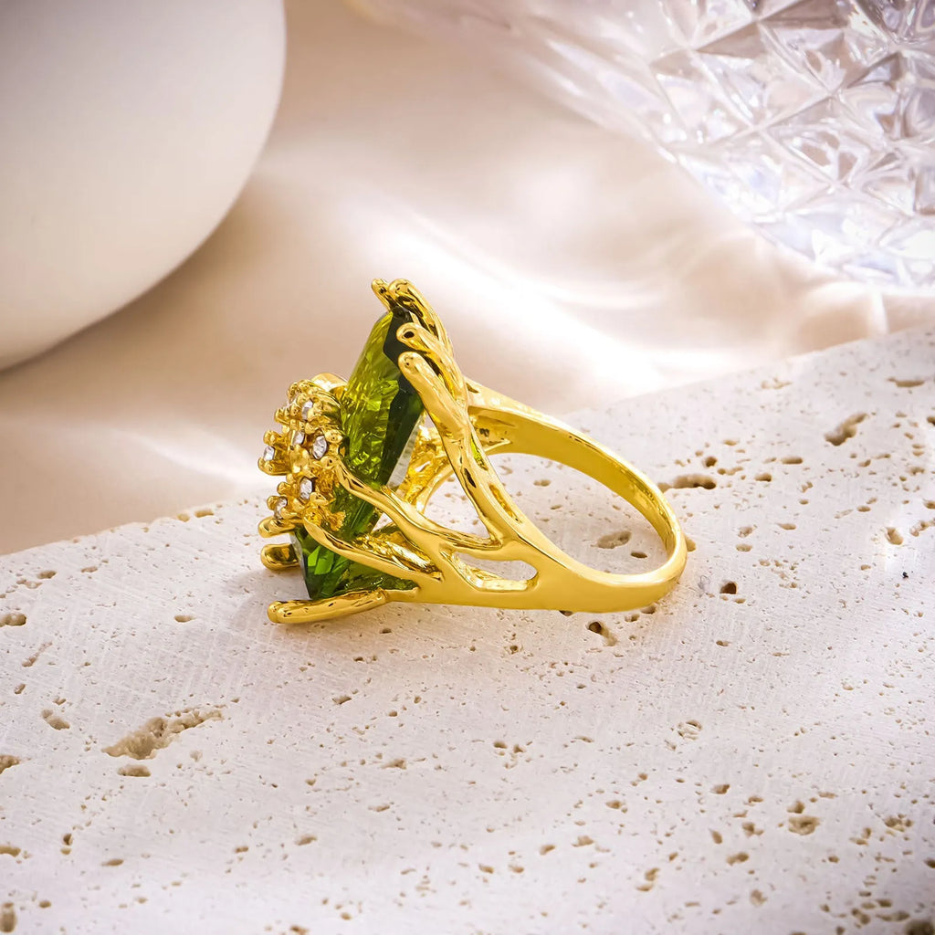 Lady's gold toned zinc alloy ring with navy blue inlaid diamond style stone