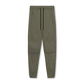 Man wearing dark grey loose-fit ankle-tied fitness trousers made from quick-drying polyester.