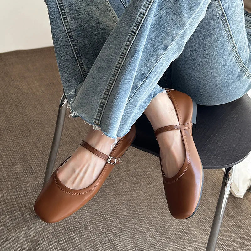 Retro brown Mary Jane flat shoes with a round toe and a single strap, showing the sheepskin upper.