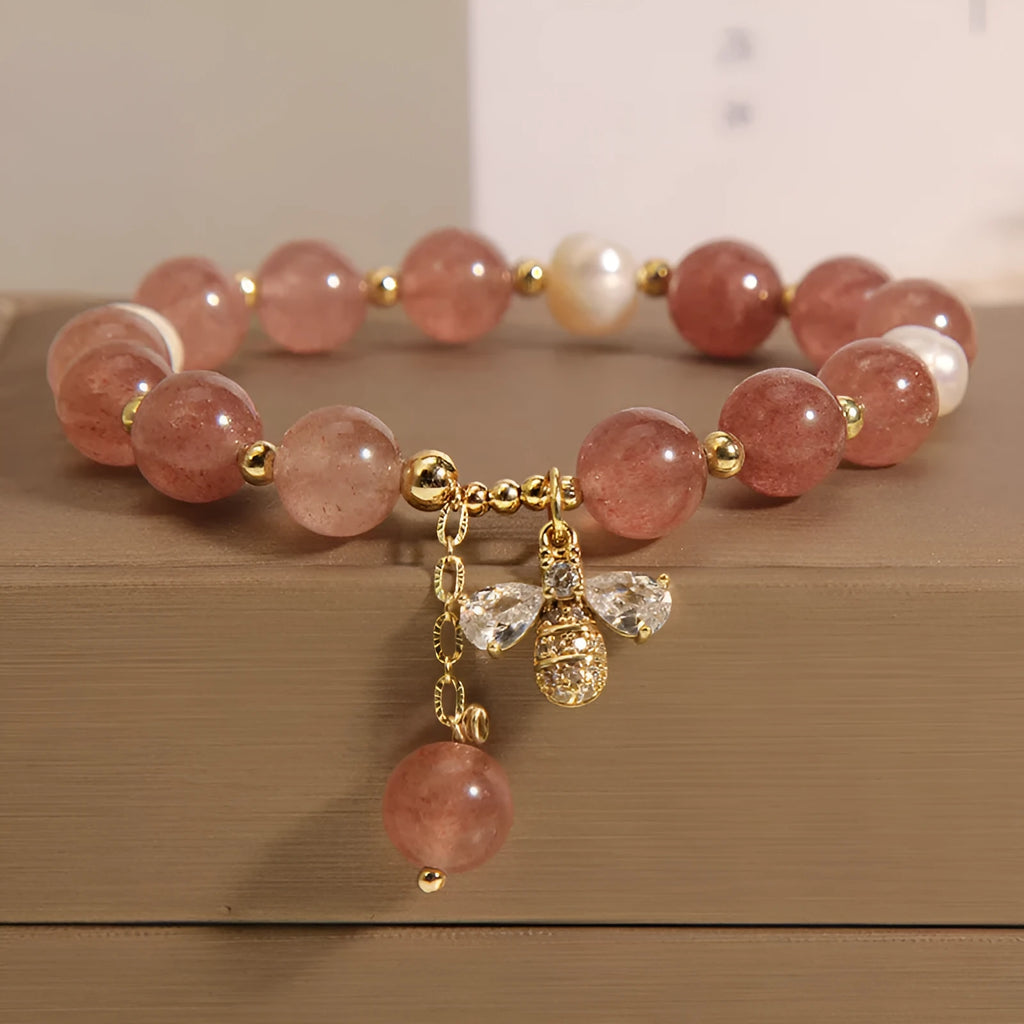 Women's bracelet with pink strawberry quartz stones, white freshwater pearls, and sparkling zircon on an alloy chain.