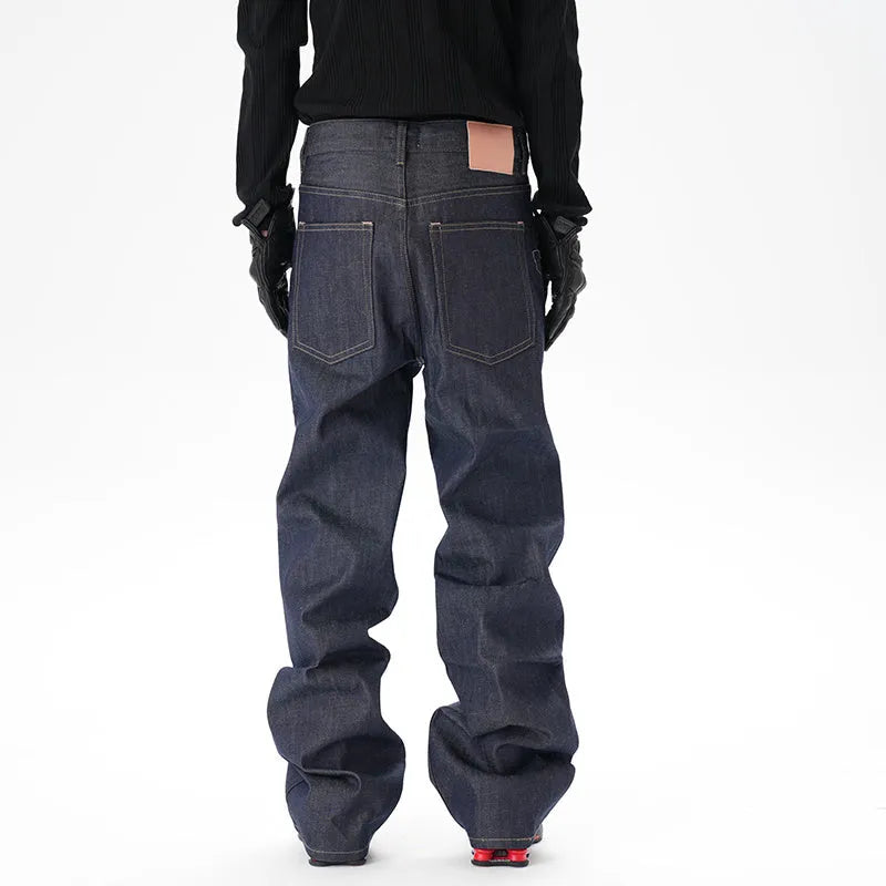 Man wearing dark blue loose fit straight leg denim jeans.