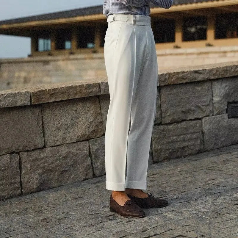 Men's slim fit straight leg suit trousers in black, white, or apricot colour on a hanger.