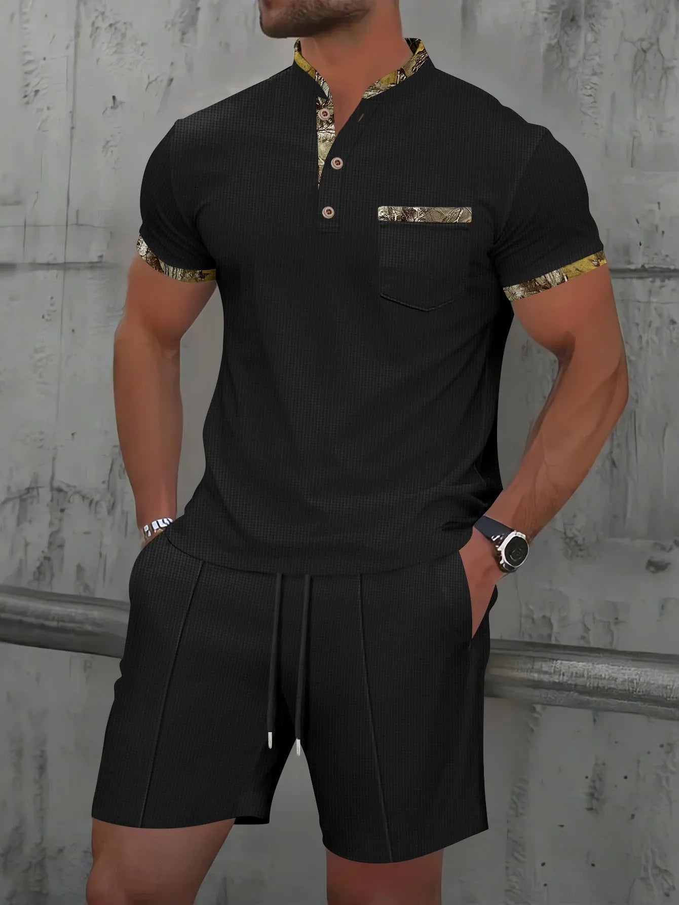 Man wearing a grey waffle knit zip-up polo collar top and matching shorts from a two-piece summer suit.