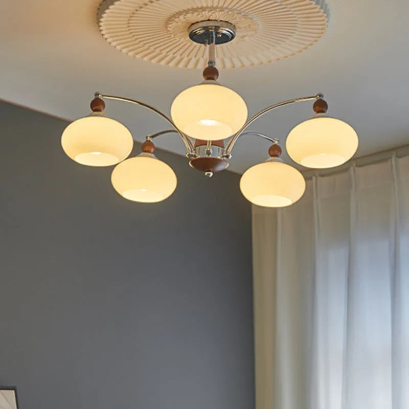 Persimmon glass and chrome chandelier with multiple glass lampshades in a choice of colours.