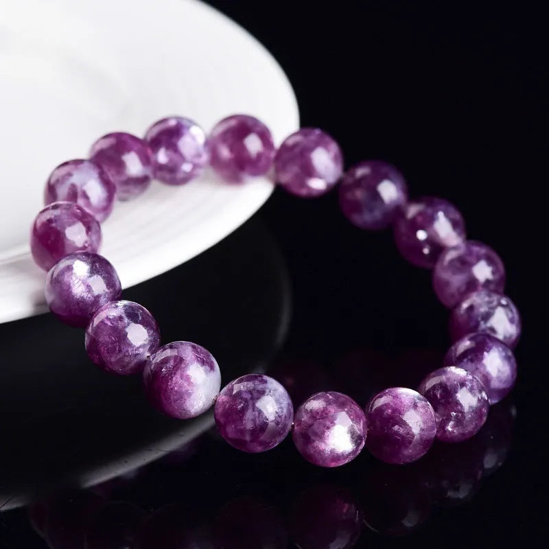 Grandmother crystal bracelet with polished geometric beads in purple on a wrist.