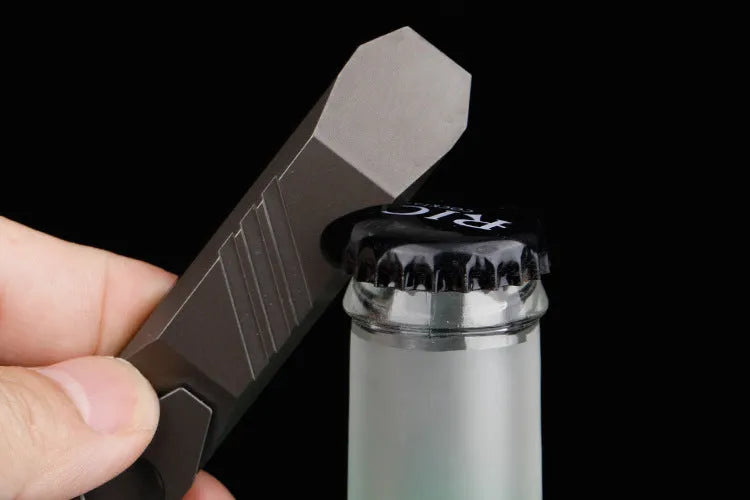 Titanium alloy multi-tool with crowbar edge, screwdriver tip, and bottle opener notches on a stone wash finish background.