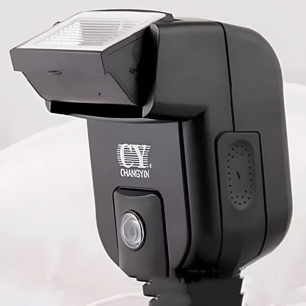 Compact silver hot shoe camera flash unit with head tilted upwards, shown on a camera.