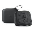 TourBox NEO black video editing controller with dials and buttons on a desk.