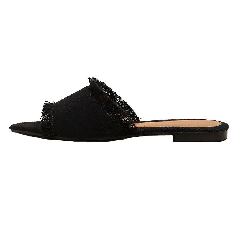 Women's denim flat slippers with tassel decoration in various colours showing leather lining and PVC soles
