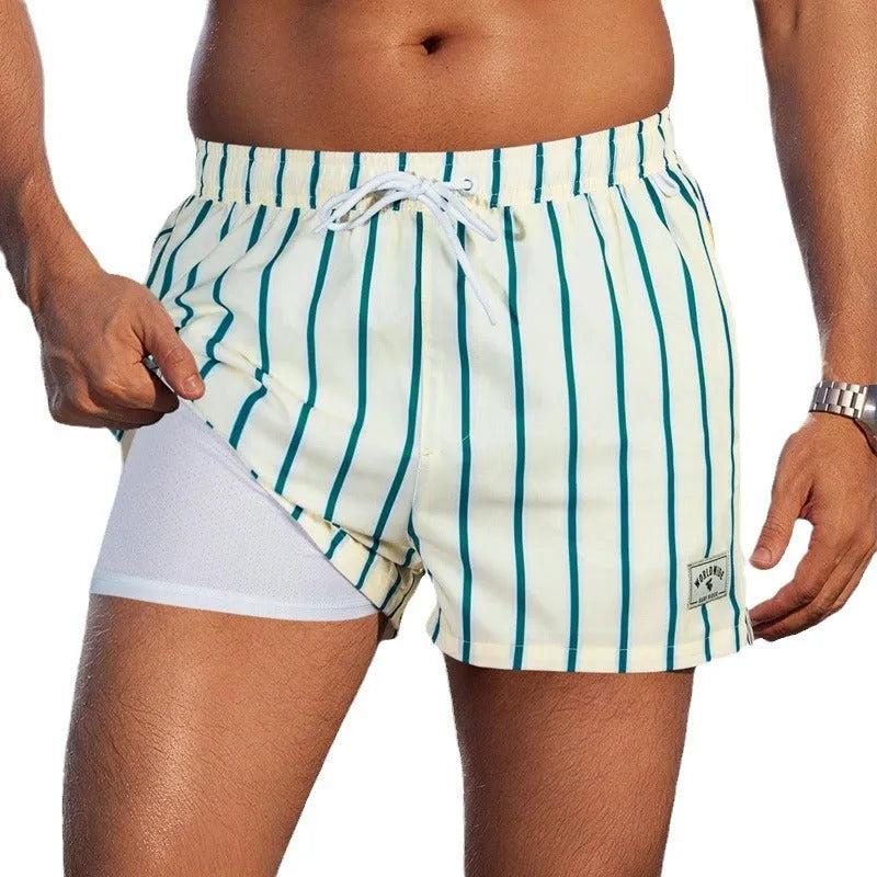 Man wearing loose green boxer-style swimming trunks made from quick-drying spandex fabric.