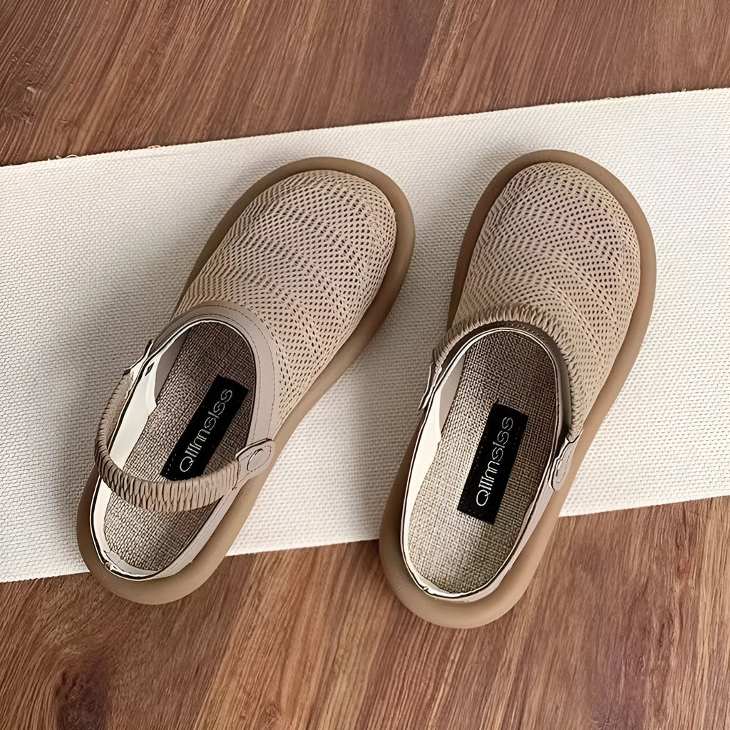 Beige linen slip-on hole shoes with mesh lining and a soft rubber sole, shown in a low-top style.
