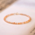 Ultra-thin 3mm sunstone crystal bracelet shown on wrist with natural colour variations