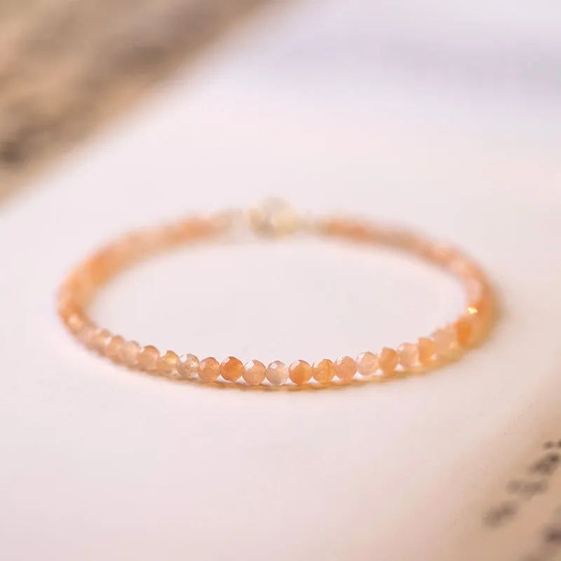 Ultra-thin 3mm sunstone crystal bracelet shown on wrist with natural colour variations