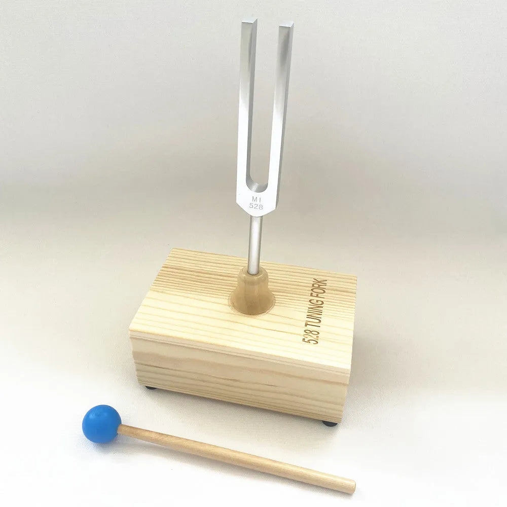 Aluminium alloy 432Hz tuning fork and portable speaker kit on a kraft paper box.