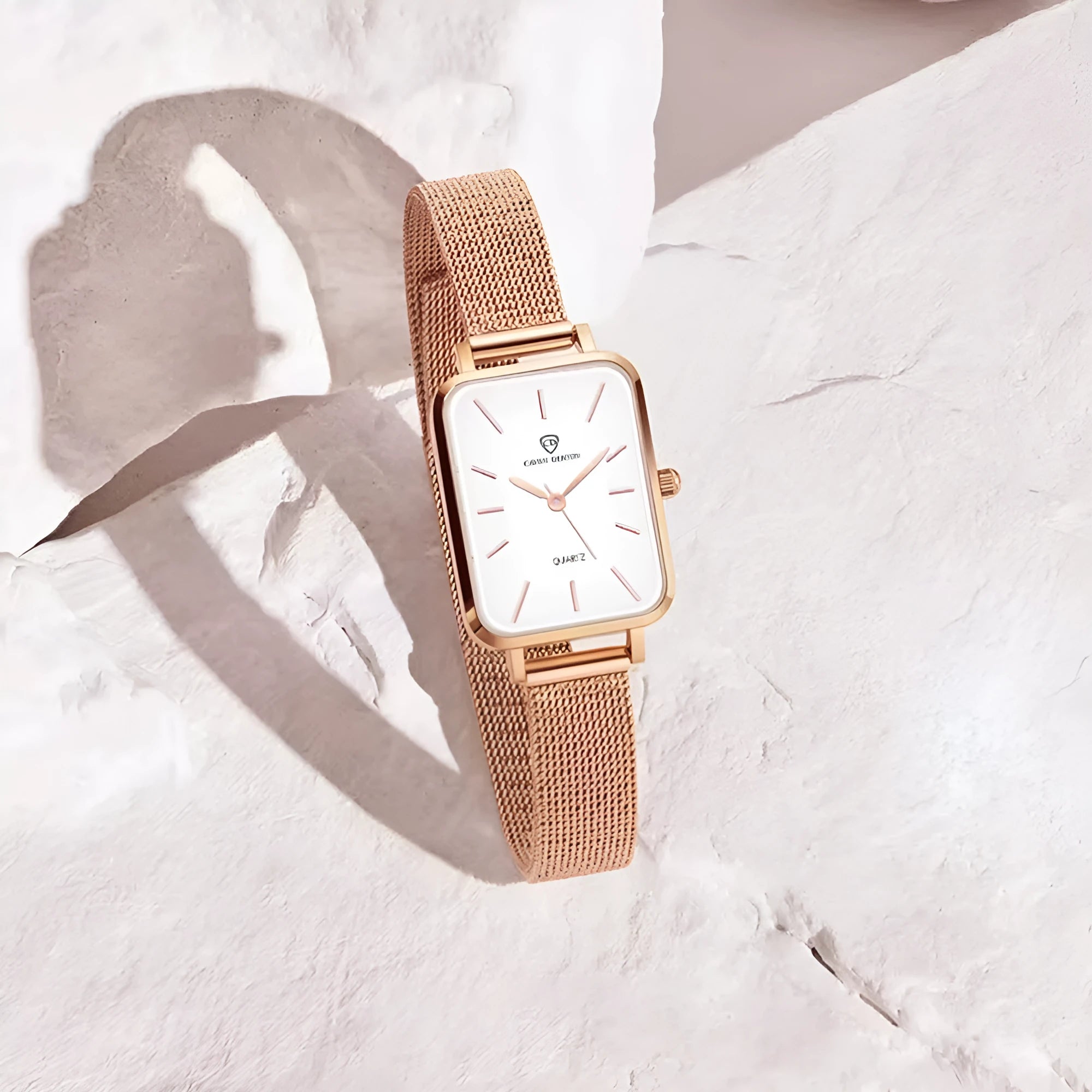 Women's rose gold quartz watch with woven steel strap and alloy case.