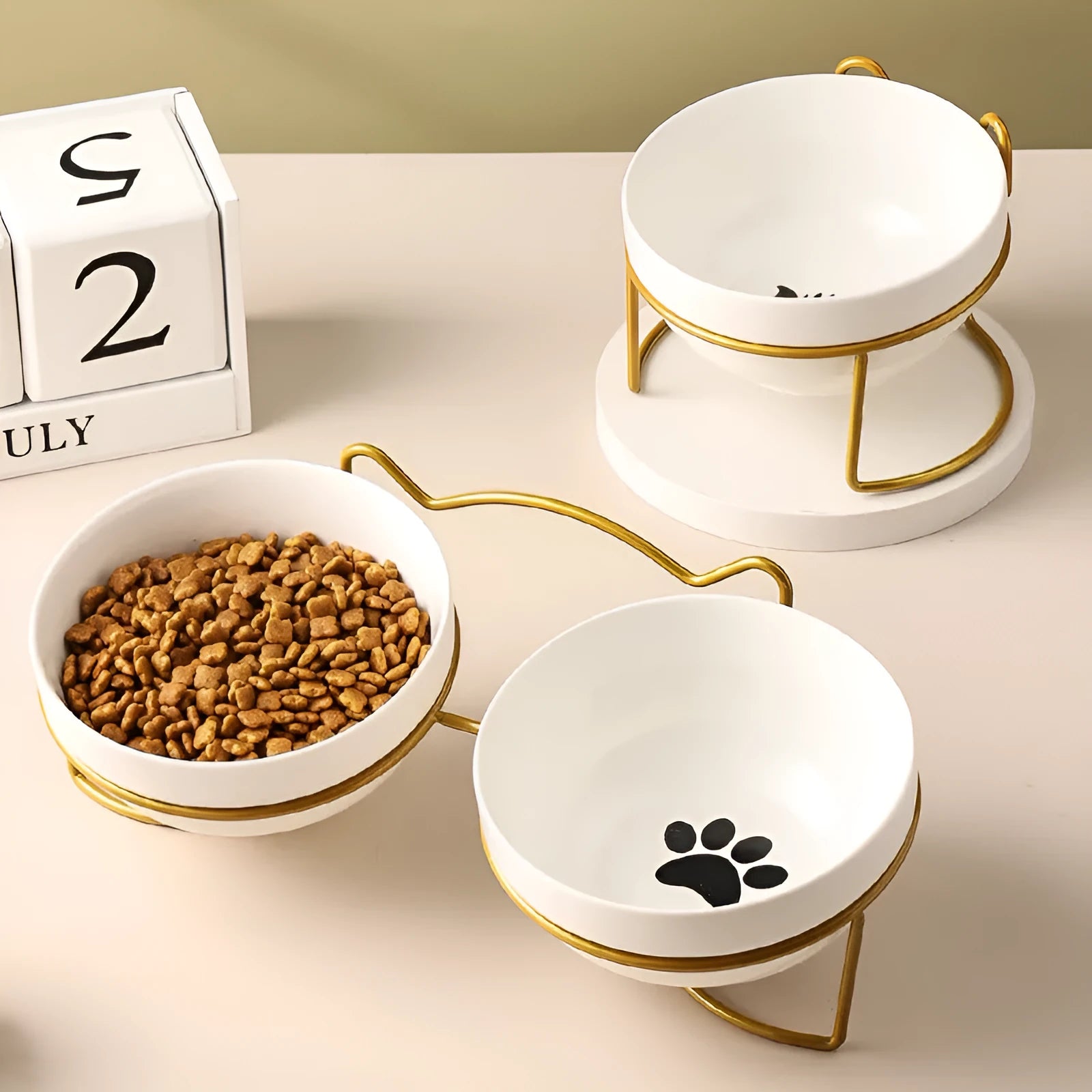 Ceramic cat bowl in an iron frame, showing cat paw print and fishbone pattern options