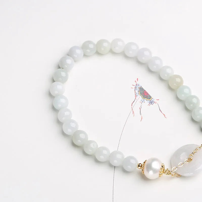 Natural emerald green jade bracelet with pearl accents and peace symbol buckle clasp