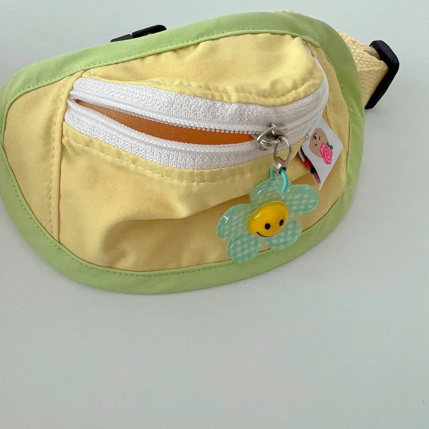 Pink and yellow messenger-style pet backpack for dogs and cats with poop bag feature