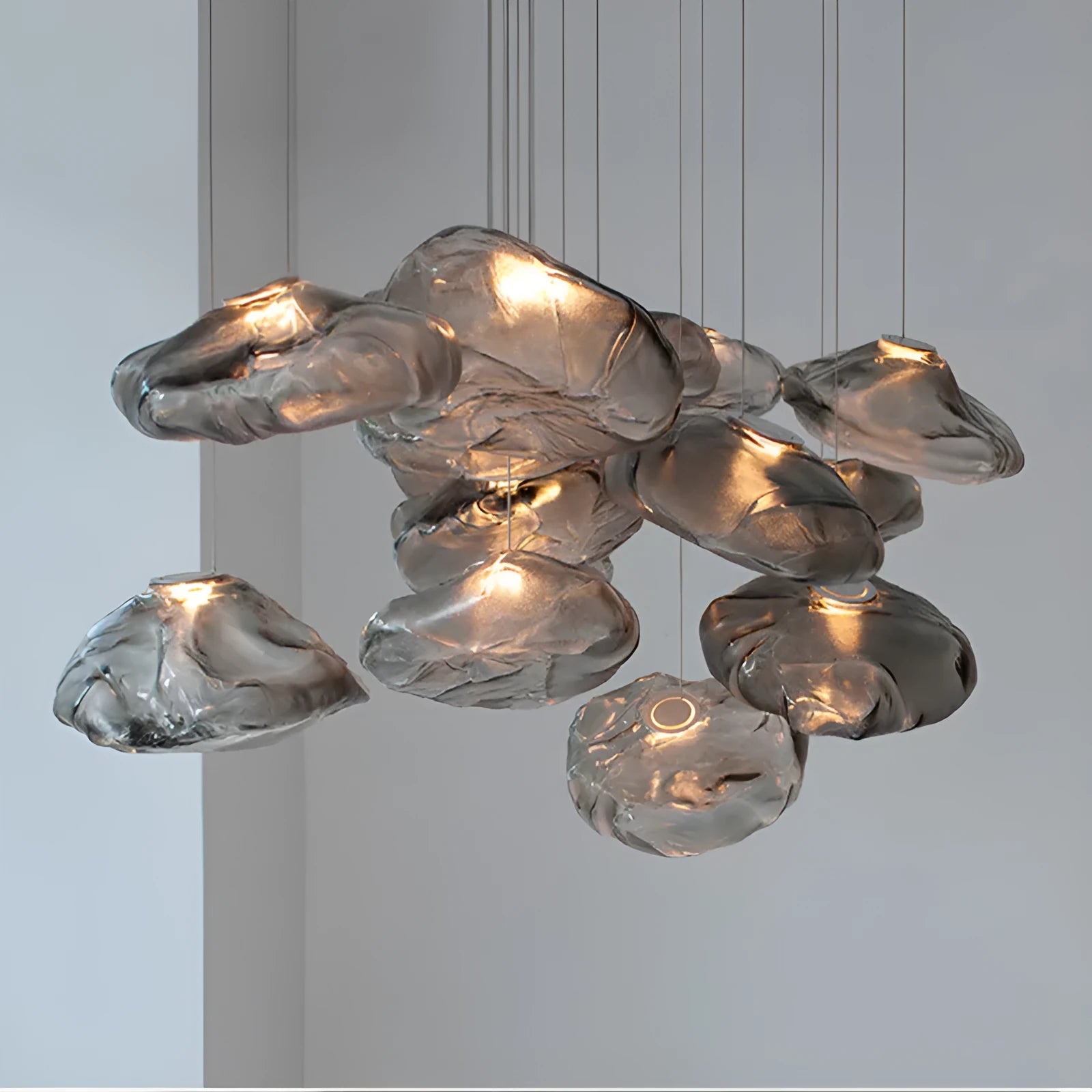 Postmodern style fabric chandelier with glass shade, shown in amber, clear, and smoke grey colours.