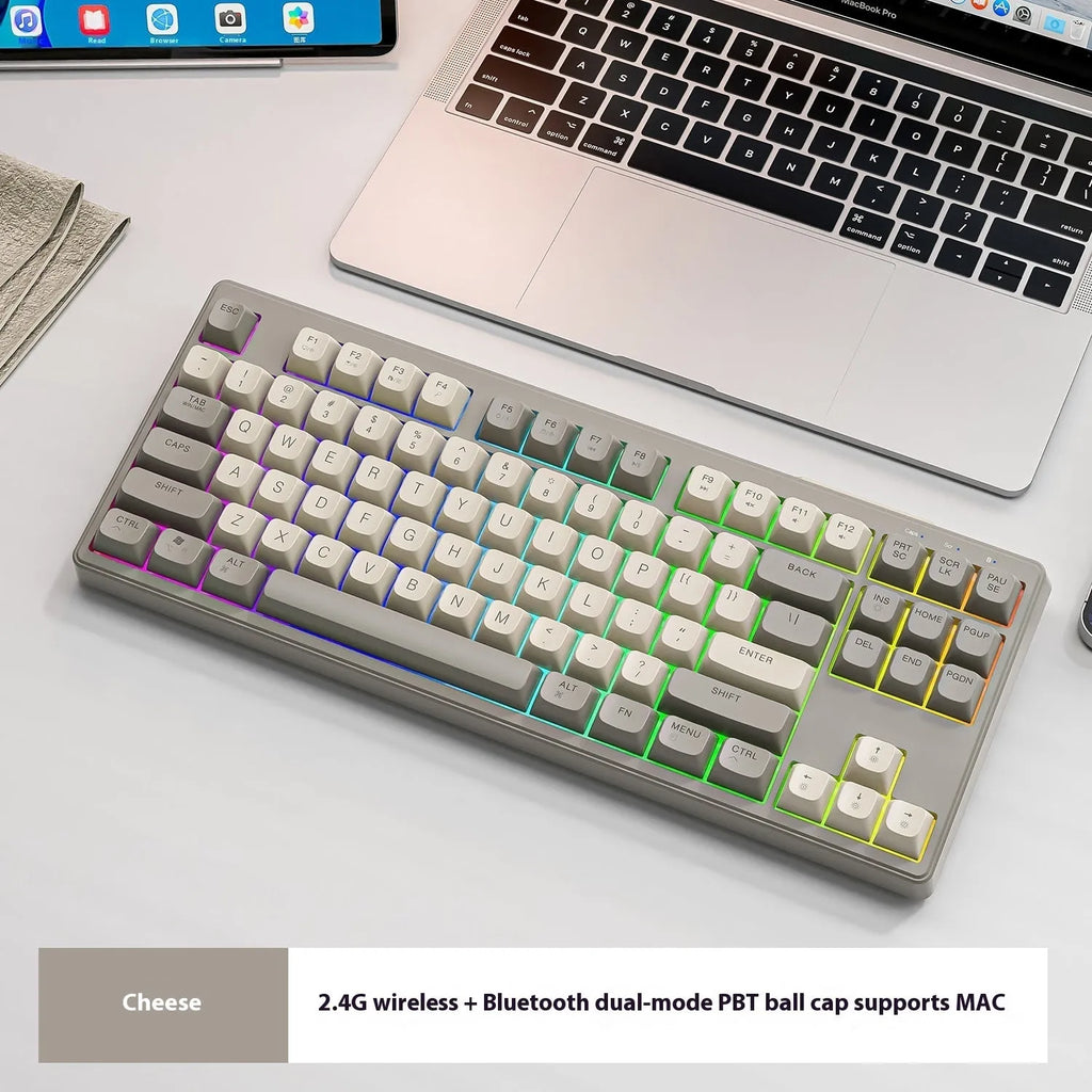 Compact wireless Bluetooth keyboard in blueberry colour with USB receiver and cable on a desk.