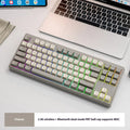 Compact wireless Bluetooth keyboard in blueberry colour with USB receiver and cable on a desk.