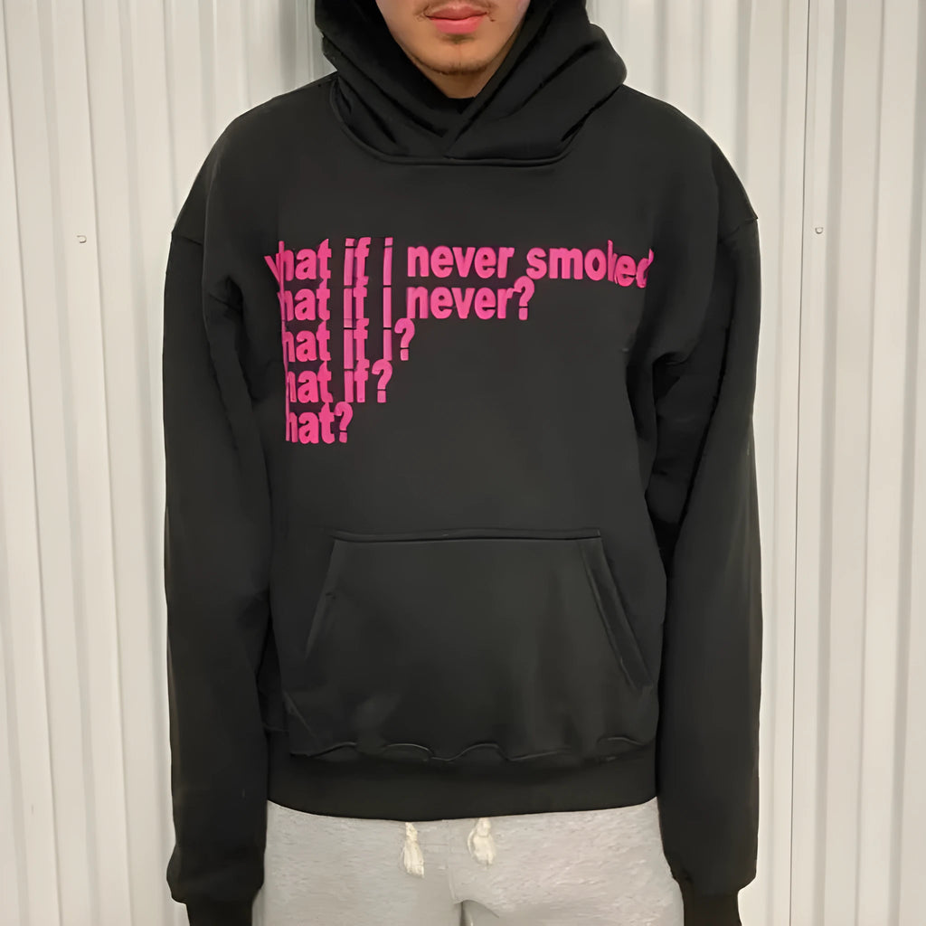 Black and grey heavy hooded sweater with printed letter graphics, showing front view with hood up