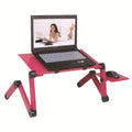 Folding metal laptop desk on bed with cooling fans and mouse board