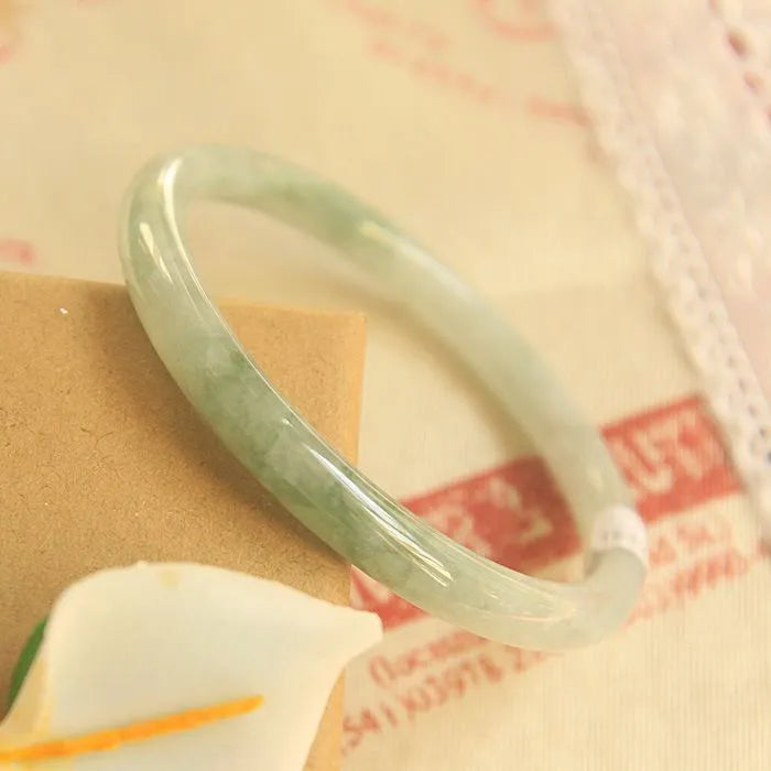 Green jade geometric bracelet with waxy finish showing 10mm width and Chinese style design