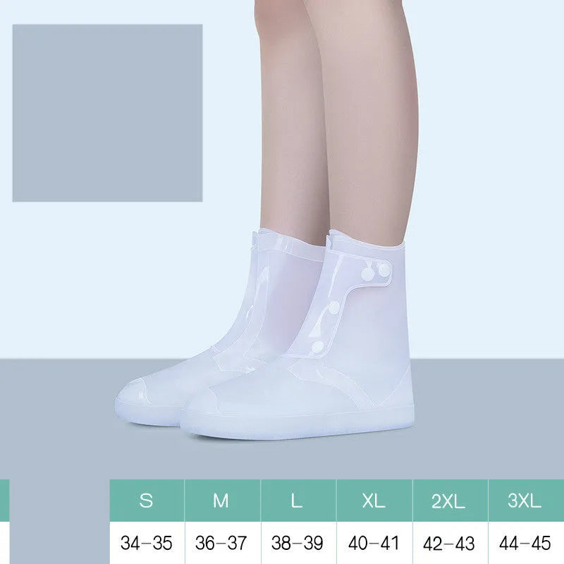 White high-top reusable PVC waterproof shoe covers with anti-skid sole on a wet surface.