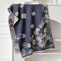 Long grey imitation cashmere winter scarf with tassel fringe on a neutral background.